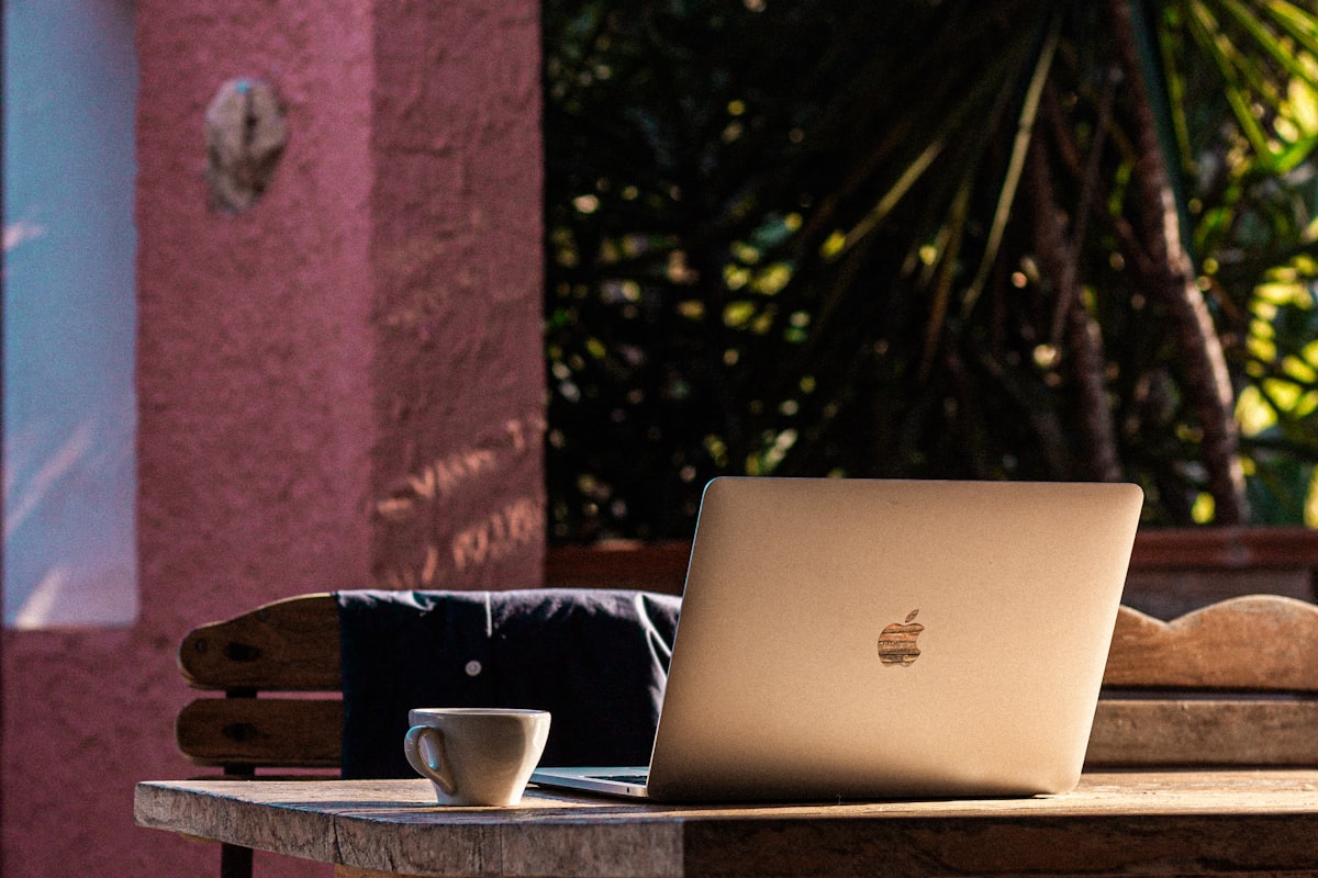 Freelancer working on a laptop in a bright apartment with city view