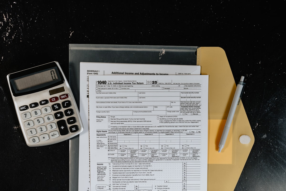 Tax documents and a passport on a desk