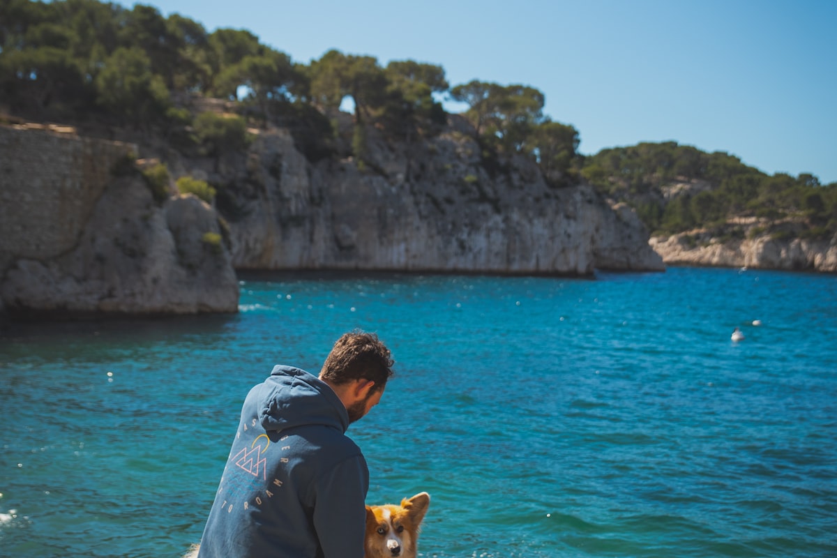 Digital nomad working from a cafe with a dog at their feet