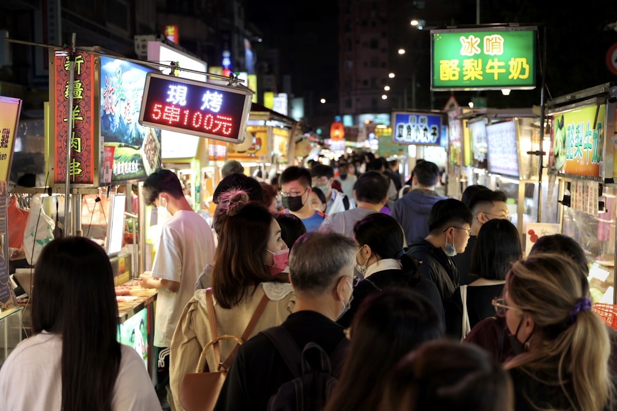 Taipei night market street food stalls with crowds