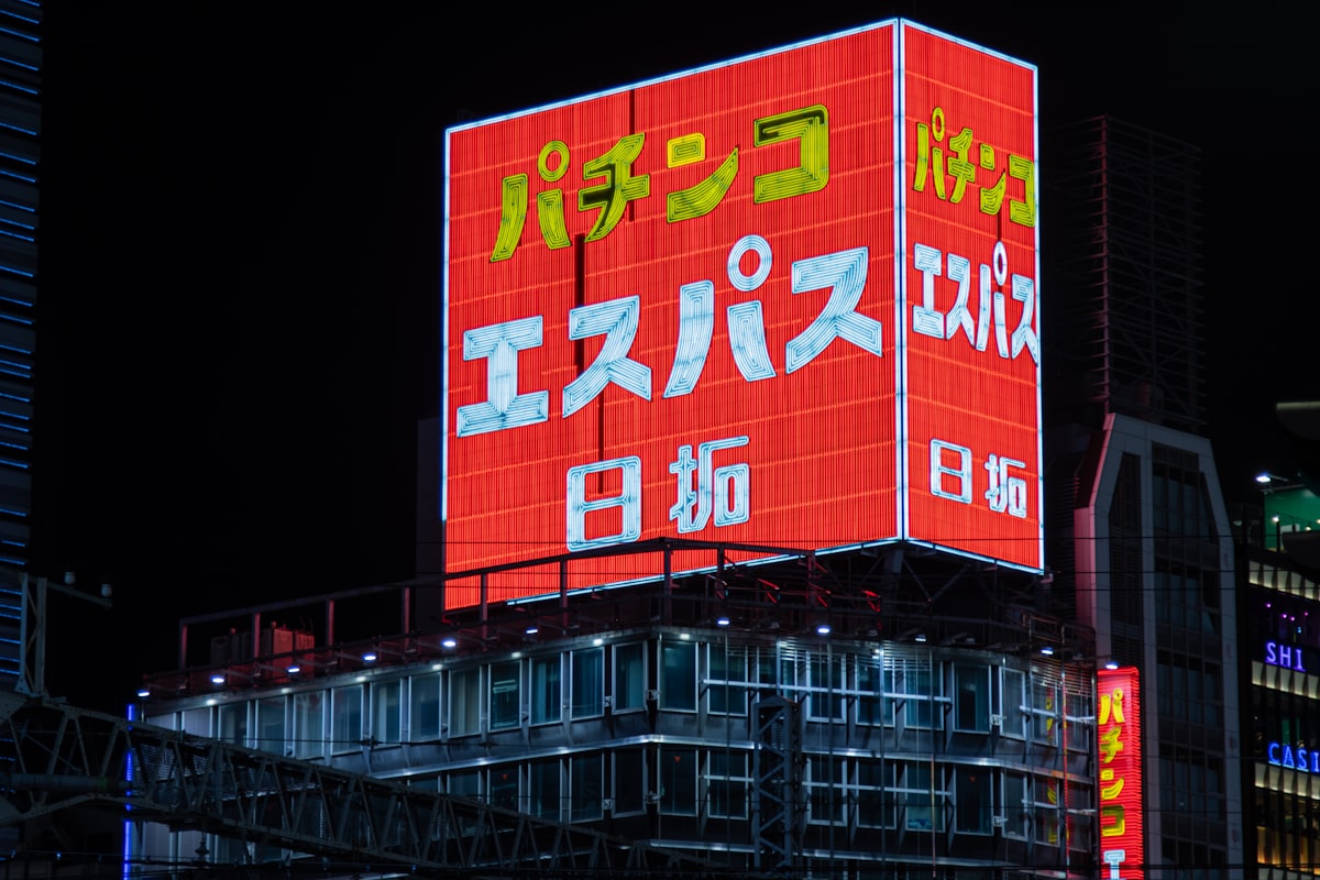Tokyo street scene in Shinjuku at night with neon signs